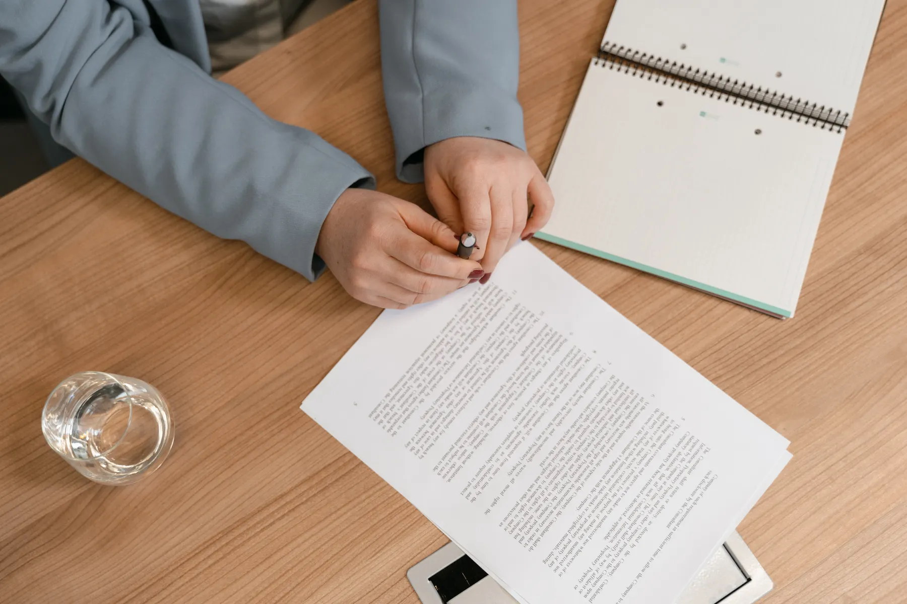 A recruiter reviews printed application documents at a desk.